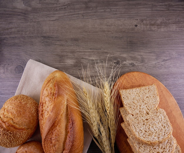 Flat lay carious of breads on wooden background with copy space