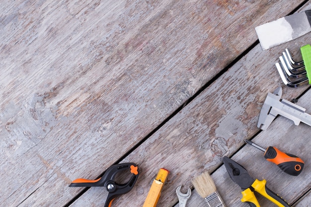 Flat lay carpenter tools on wooden background