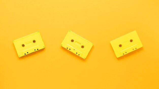 Photo flat lay of cassettes on yellow background