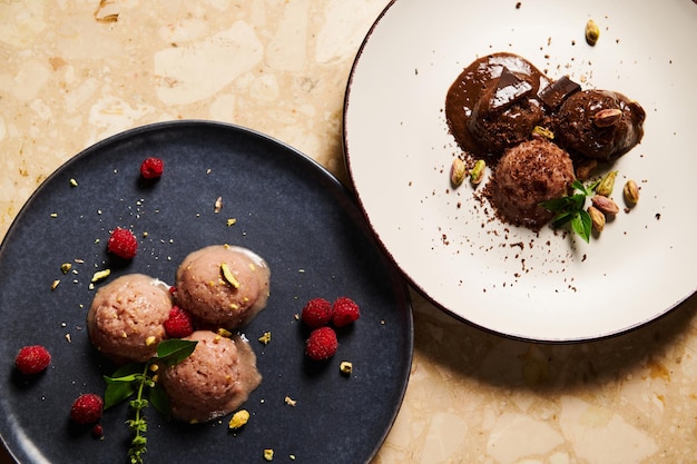 Photo flat lay of ceramic plates with scoops of raw vegan ice cream sorbet on a marble table background food still life