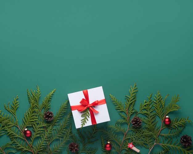 Flat lay christmas background with green tree, toy and present. Top view