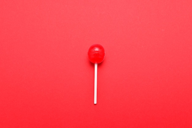 Flat lay of close up on red lollipop