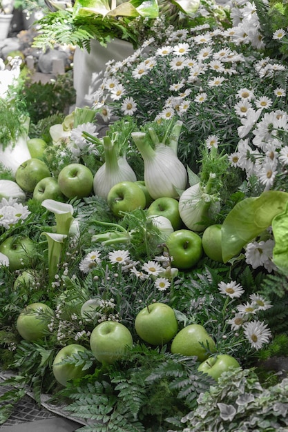 Flat lay and closeup assortment of freshly picked vegetable fennel bulbs and green apples