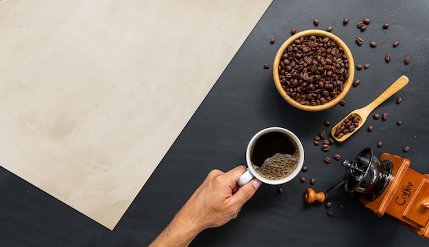 Flat lay of coffee beans and grinder