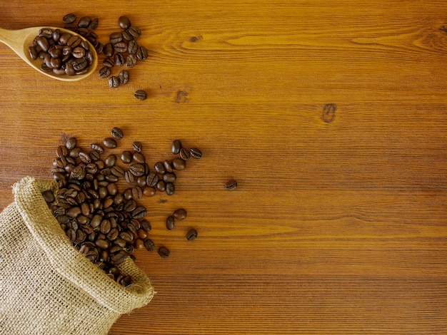 Flat lay coffee beans on wooden background with copy space