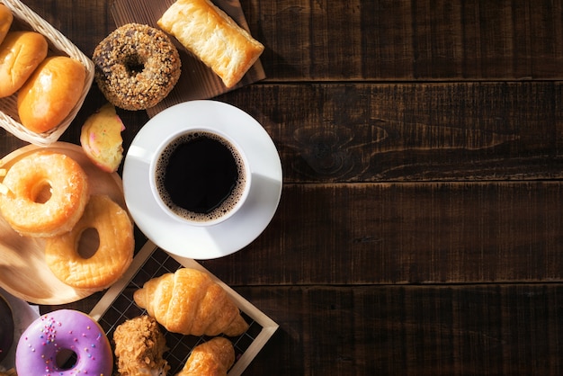 Flat lay of coffee cup and assorted junk food