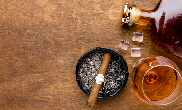 Flat lay cognac and cigar with copy space