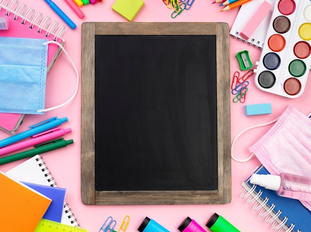 Photo flat lay of colorful back to school stationery with blackboard