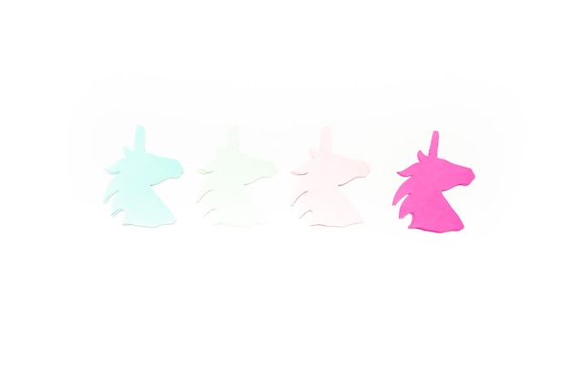 Flat lay. Colorful unicorn paper cutouts on a white background.