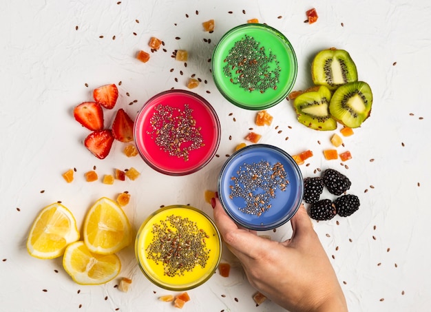 Flat lay colourful smoothies in glasses