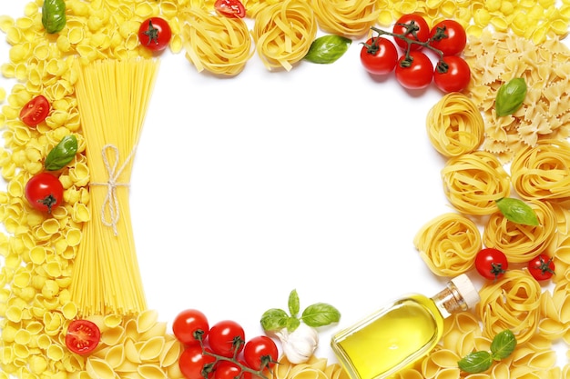 Flat lay composition frame from raw different pasta, fettuccine balls, cherry tomatoes,  spices, basil, olive oil, garlic isolated on a white background.