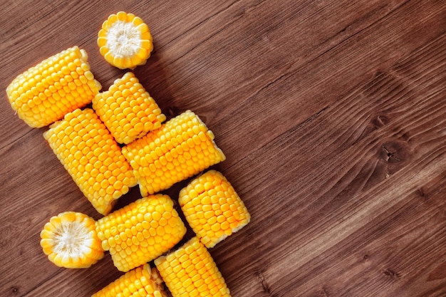 Photo flat lay composition of fresh corn cobs on a wooden background top view copy space for text