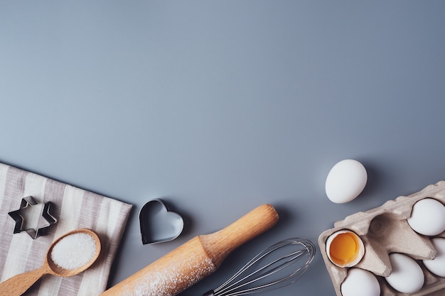 Flat Lay composition, ingredients for baking cookies on a gray background, copy space. Making cookies or cupcakes for Valentine's Day, Mother's Day, Father's Day. The concept of festive food.