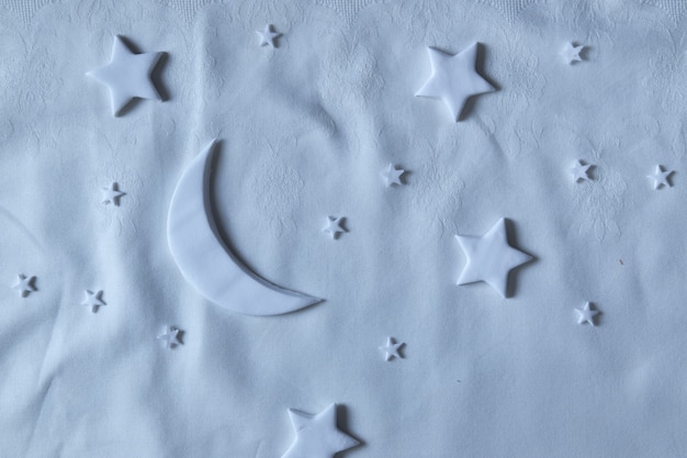 Photo flat lay composition of the moon and stars on the sheet. dream creative concept