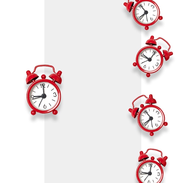 Flat lay composition of red alarm clocks on gray 