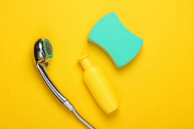 Flat lay composition of shower head for the bathroom and bath products