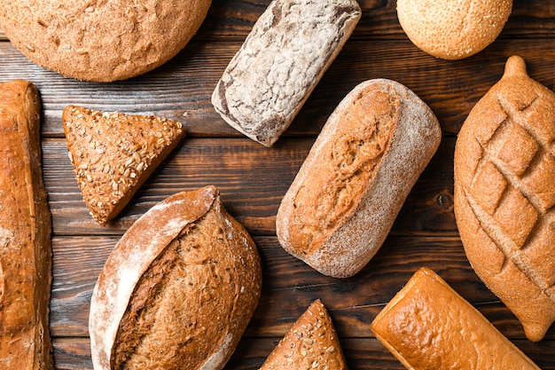 Flat lay composition with bakery products on wooden space, top view and closeup