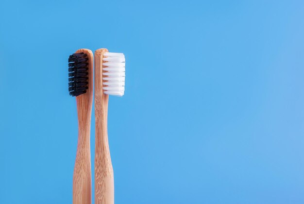 Flat lay composition with bamboo toothbrush space for text on color background