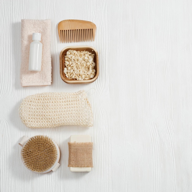 flat lay composition with bath accessories with bottles gel and shampoo soap sea salt washcloth