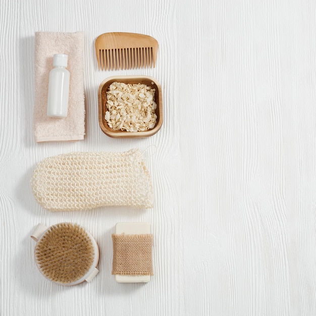 Flat lay composition with bath accessories with bottles gel and shampoo soap sea salt washcloth