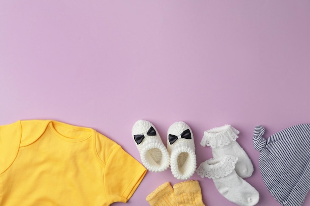 Flat lay composition with child39s clothes on violet background space for text