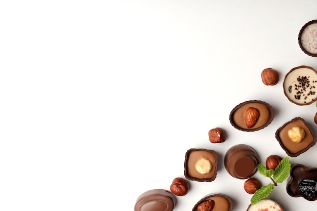 Photo flat lay composition with chocolate candies on white background