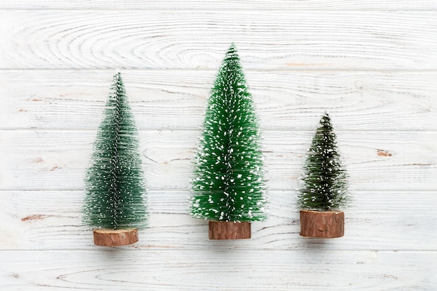 Photo flat lay composition with christmas trees on color background. top view with copy space