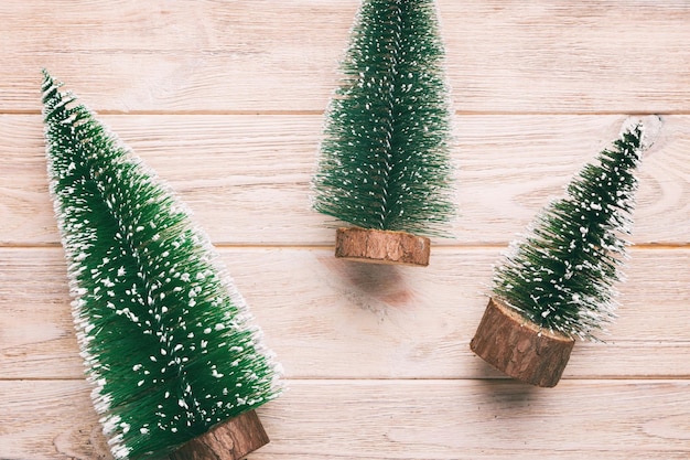 Flat lay composition with christmas trees on color background Top view with copy space