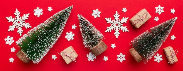 Flat lay composition with christmas trees on color background Top view with copy space