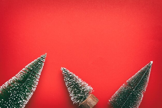 Flat lay composition with christmas trees on color background Top view with copy space