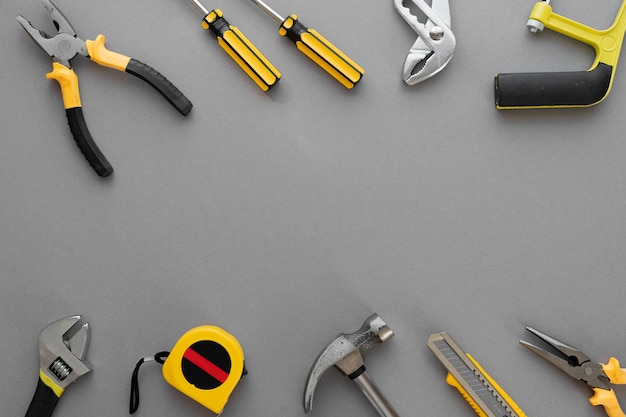 Photo flat lay composition with construction and home repair tools tools on grey background, space for text
