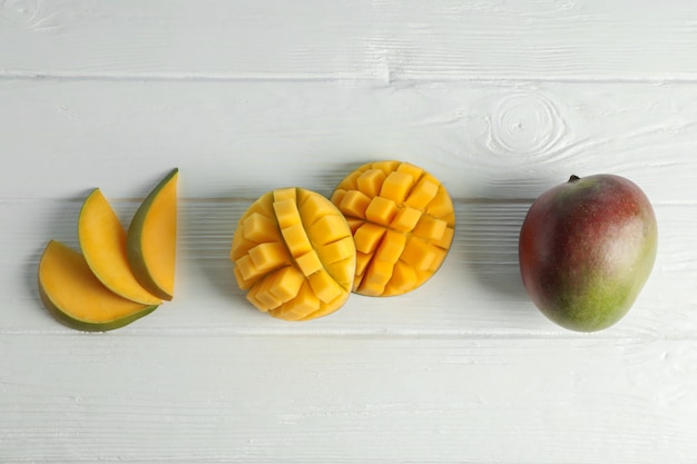 Flat lay composition with cut ripe mangoes