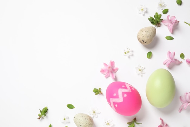 Flat lay composition with Easter eggs on white background Space for text