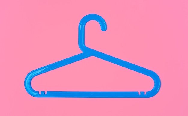 Photo flat lay composition with empty hangers on pink background