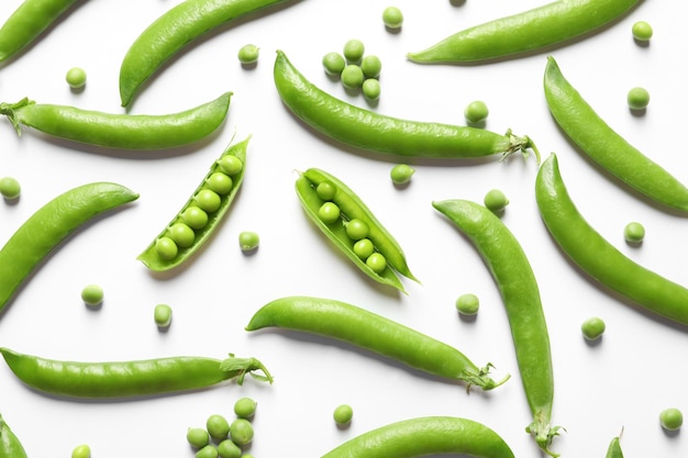 Flat lay composition with fresh peas on white background