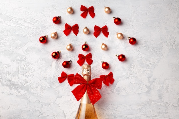 Flat lay composition with gold champagne bottle and Christmas balls