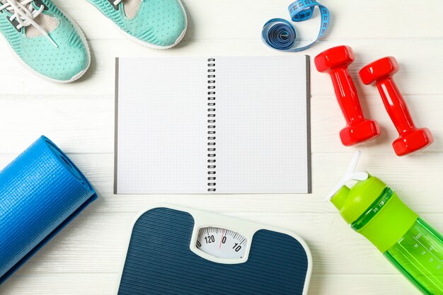 Flat lay composition with loss weigh accessories on white wooden background