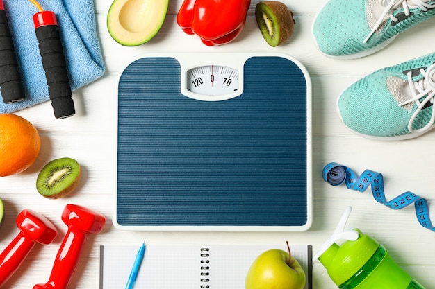 Flat lay composition with loss weigh accessories on white wooden background