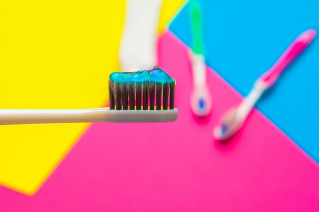 Flat lay composition with manual toothbrushes on color, close up