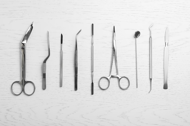 Photo flat lay composition with medical objects on white wooden background