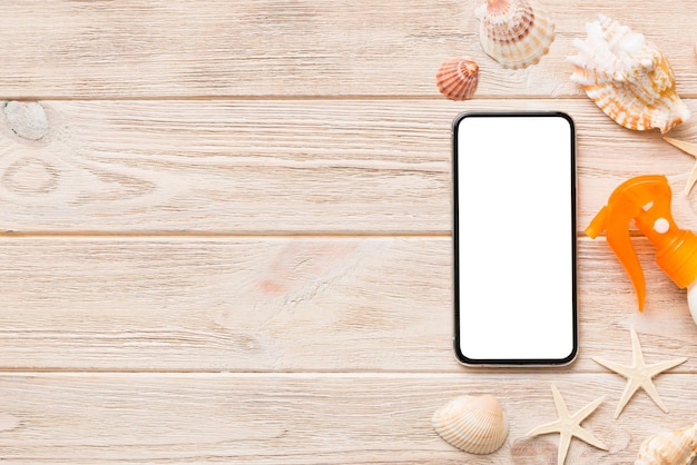 Flat lay composition with Phone and beach accessories on colored background Smartphone with blank screen mock up with copy space