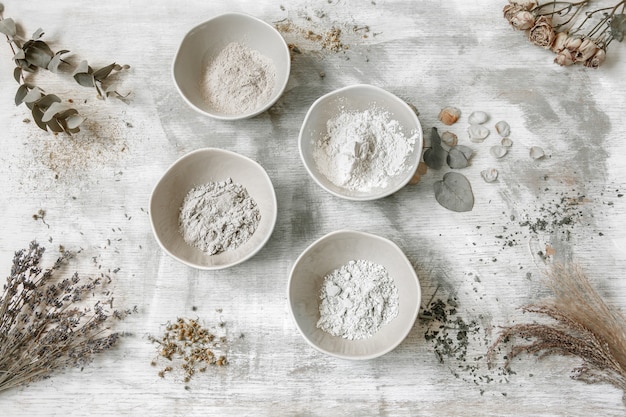 Flat lay composition with the preparation of a face mask from clay