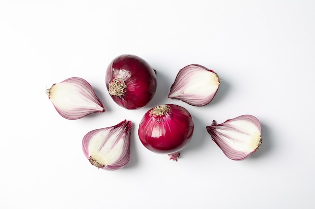 Flat lay composition with red onion and spices on white