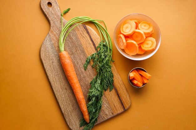 Flat lay composition with ripe fresh and chopped carrot