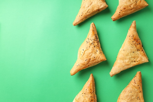 Flat lay composition with samsa on green background