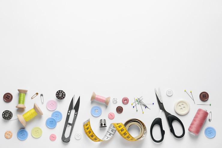 Photo flat lay composition with scissors and sewing supplies on white background space for text