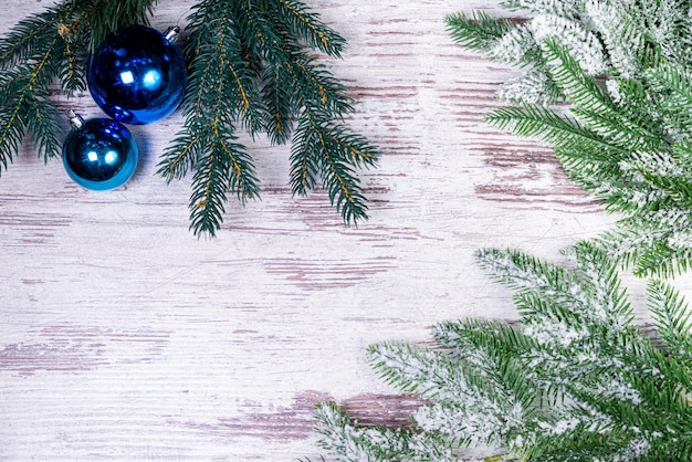 Flat lay composition with serpentine streamers and Christmas decor on wooden background Space for text Balls branches hat