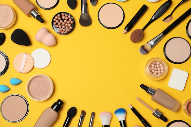 Flat lay composition with skin foundation powder and beauty accessories on color background Space for text