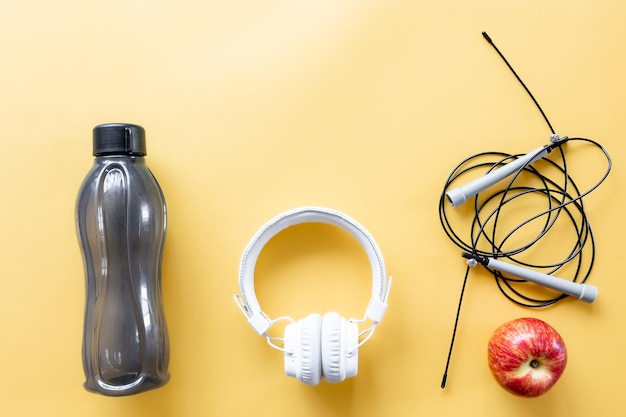 Flat lay composition with sports equipment on yellow background