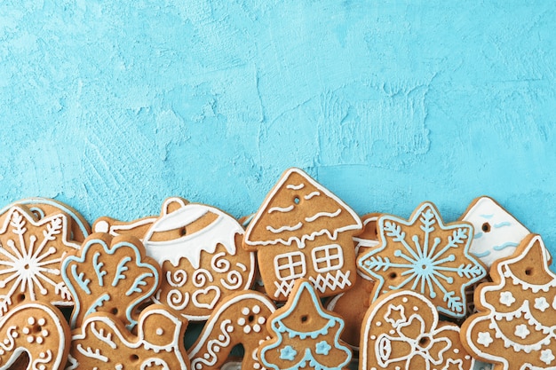 Flat lay composition with tasty homemade Christmas cookies on blue, space for text. Top view